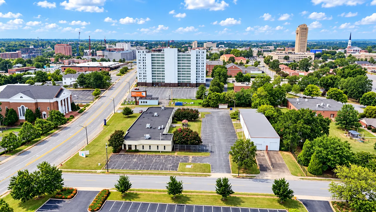 Elevated view over the campus toward downtown Spartanburg, with South Church Street on the left and the downtown towers on the skyline.